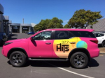 Hot pink vehicle graphics for The Hits